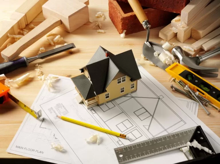 Contractor writing up a detailed itemized renovation quote for a homeowner