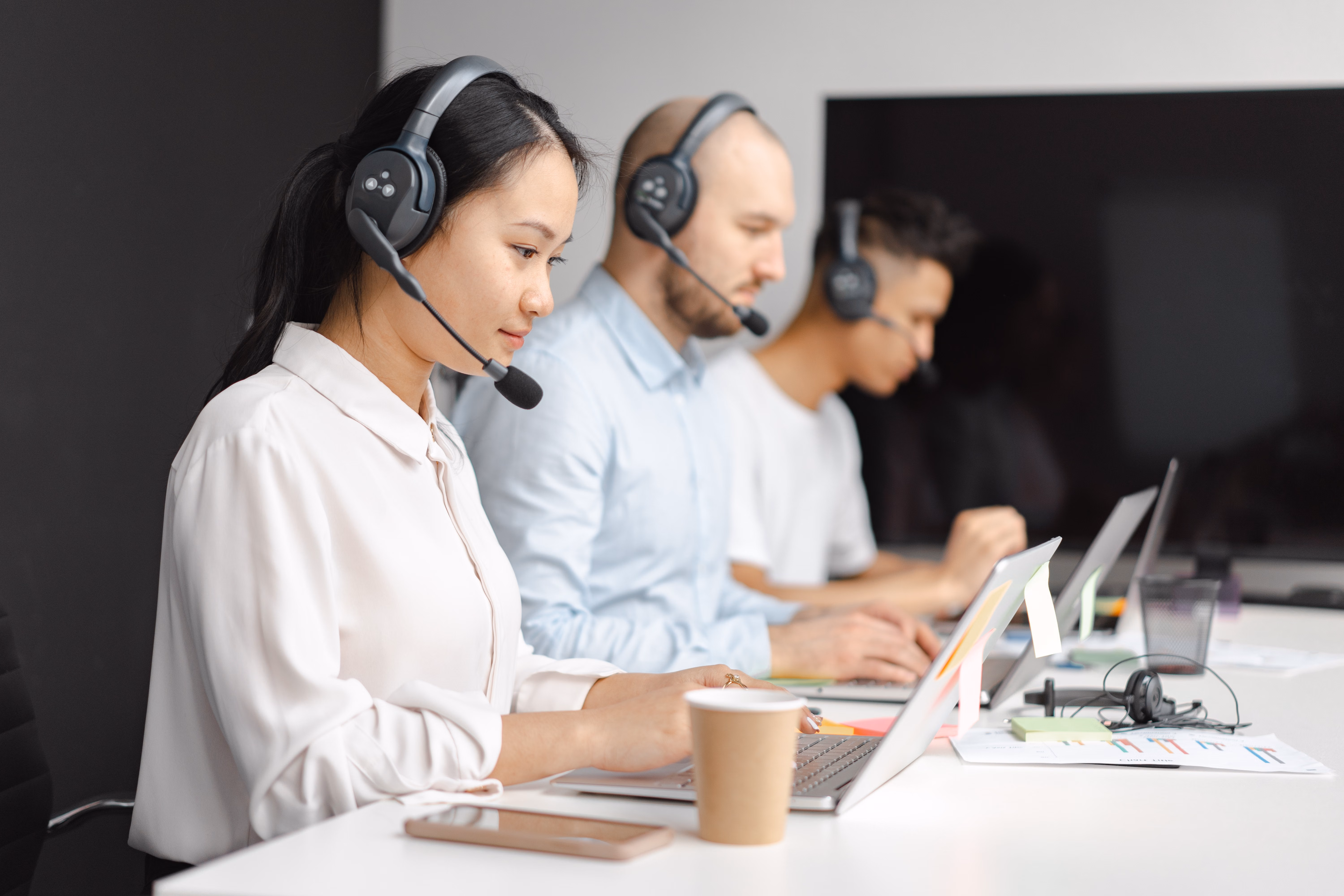 Call center agent reviewing lead data on a laptop screen in a modern office