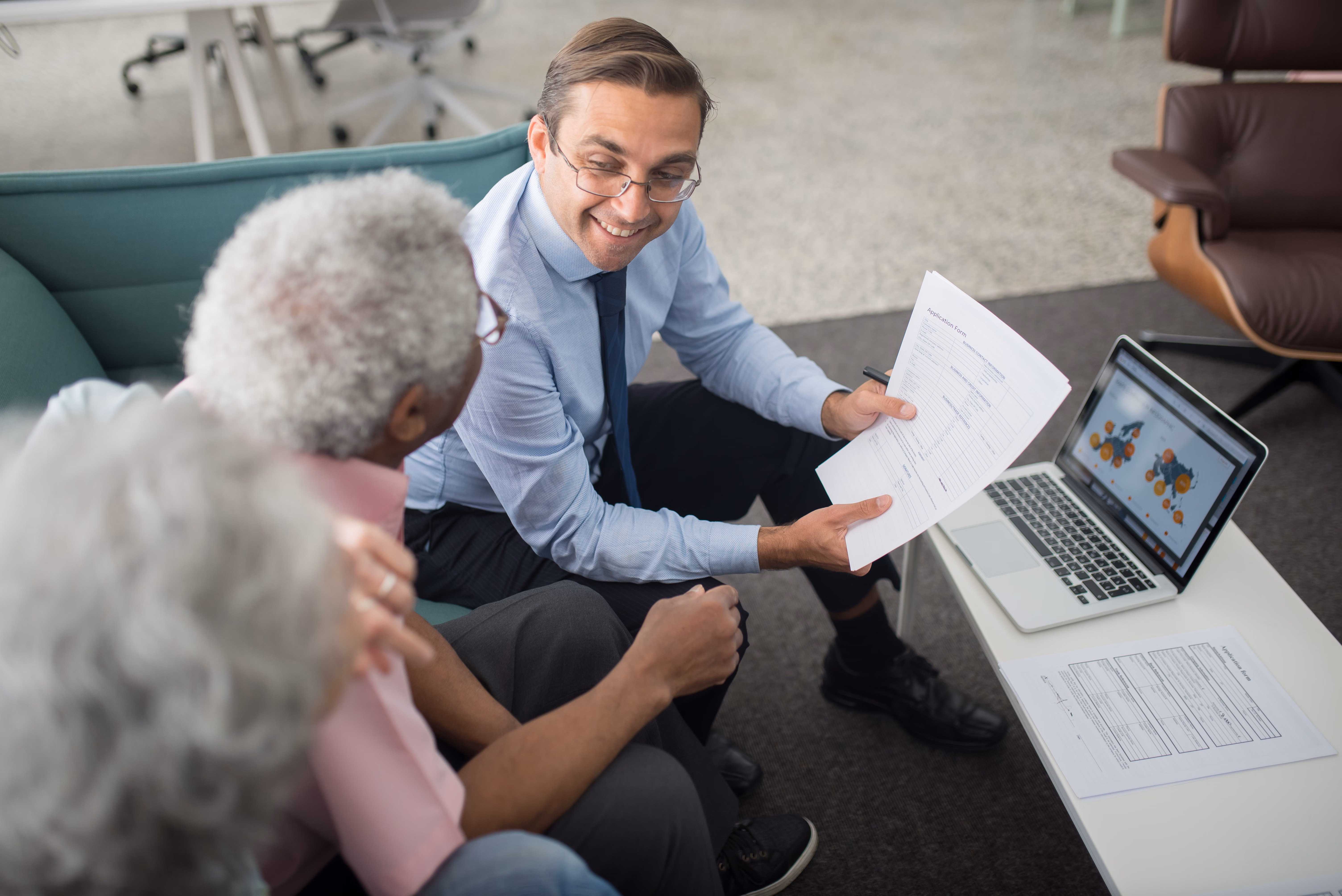 Insurance agent reviewing life insurance policy documents with a client