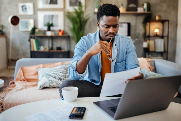 Person comparing loan offers on a laptop and smartphone