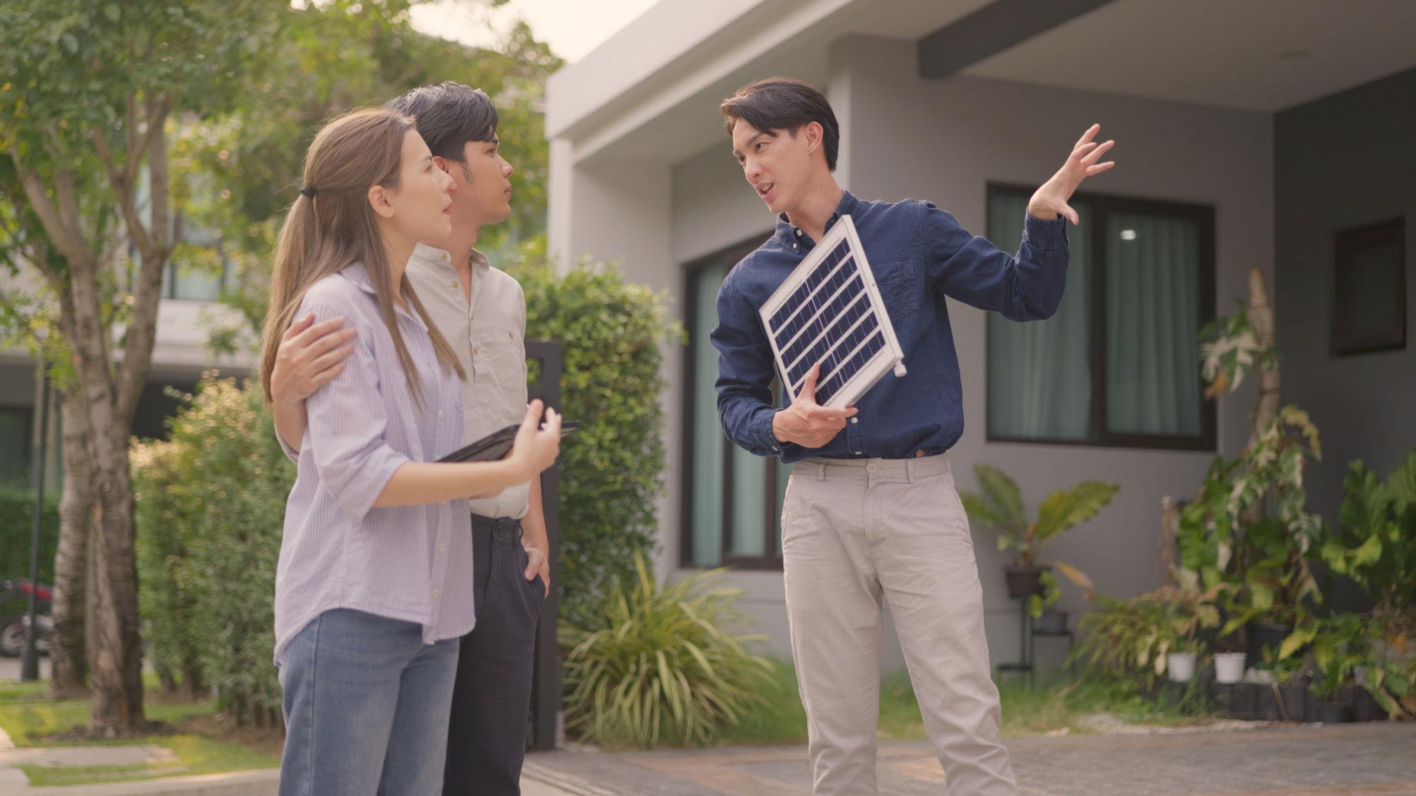Solar sales consultant reviewing a proposal with a homeowner
