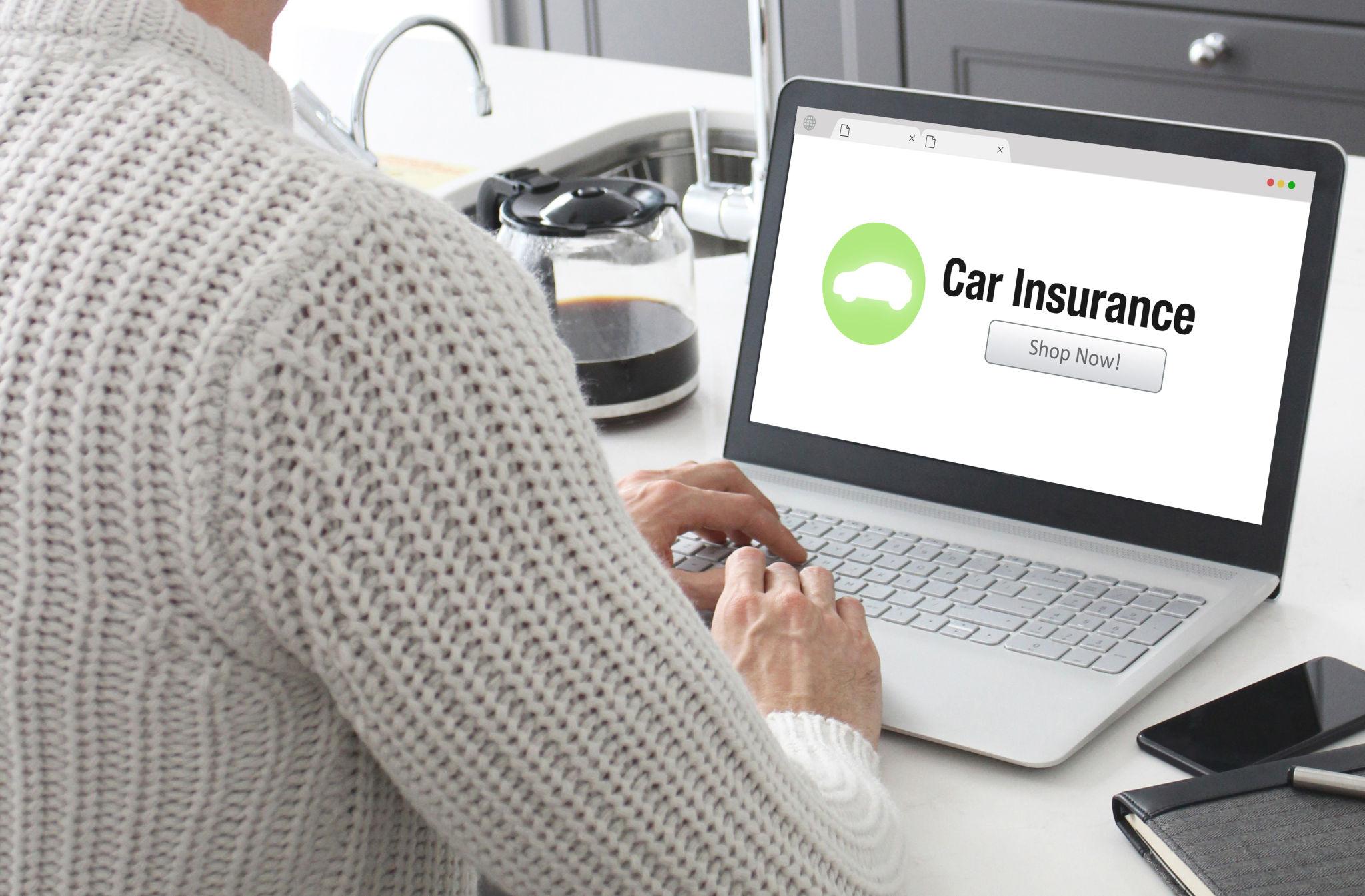 Person researching auto insurance options online during the awareness stage of the buyer's journey
